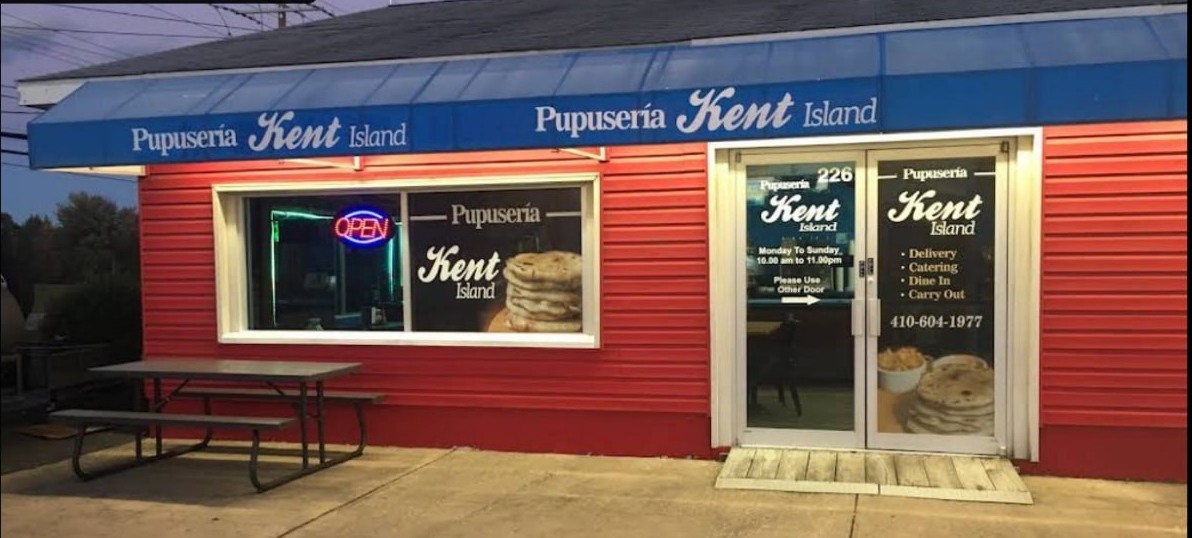 Pupusería Kent Island restaurant at magic hour — red building with blue awning in Stevensville, Maryland